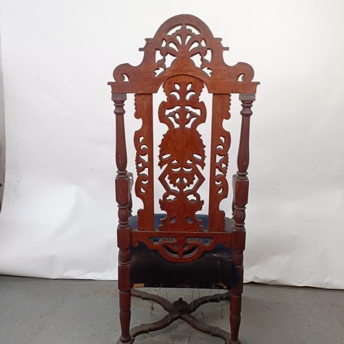 124 - A late 19th century oak armchair, with carved back, 130 cm high