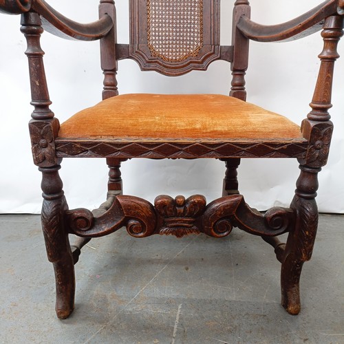 125 - A 17th century style oak armchair, with carved bergere back and padded drop in seat