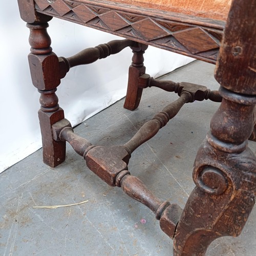 125 - A 17th century style oak armchair, with carved bergere back and padded drop in seat