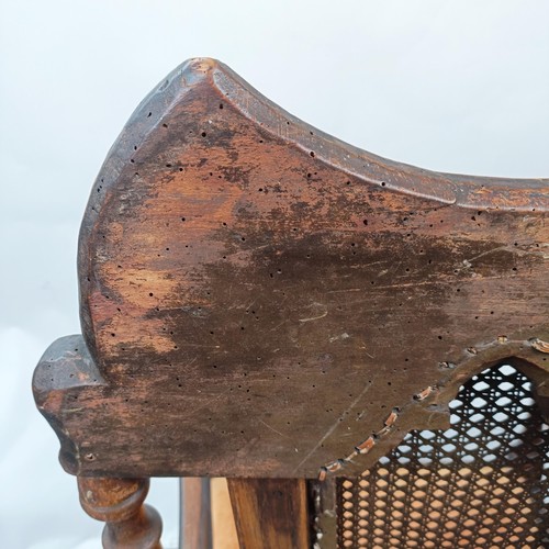 125 - A 17th century style oak armchair, with carved bergere back and padded drop in seat