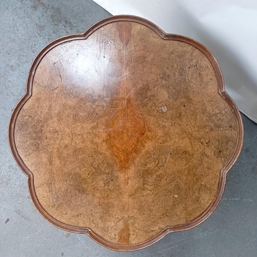 130 - A burr walnut coffee table, 65 cm wide