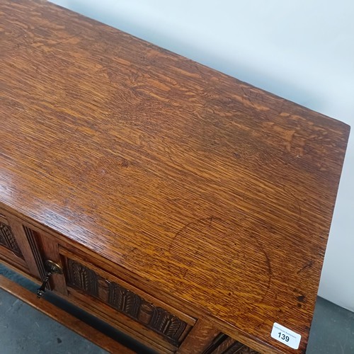 139 - A 17th century style oak cabinet, with carved decoration, 92 cm wide