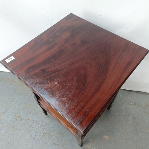 140 - A mahogany two tier lamp table, 48 cm wide