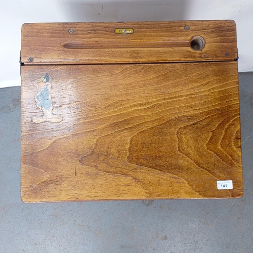 141 - An oak school desk, 56 cm wide