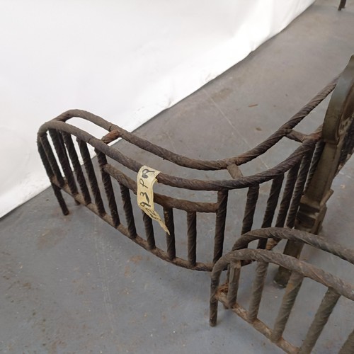 148 - An unusual pair of Aesthetic Period iron and brass fenders, 153 cm wide (2)