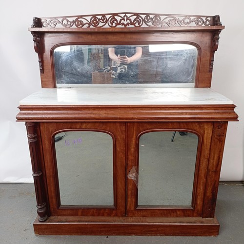 153 - A Victorian mahogany chiffonier with a mirrored back, the base with a marble top, and two mirrored c... 