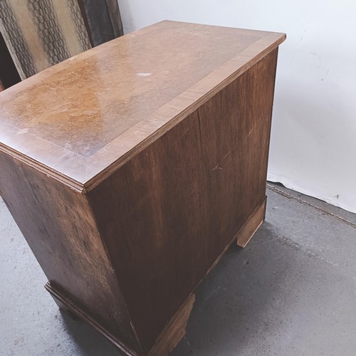 251 - A George III style walnut bow front chest, having four drawers