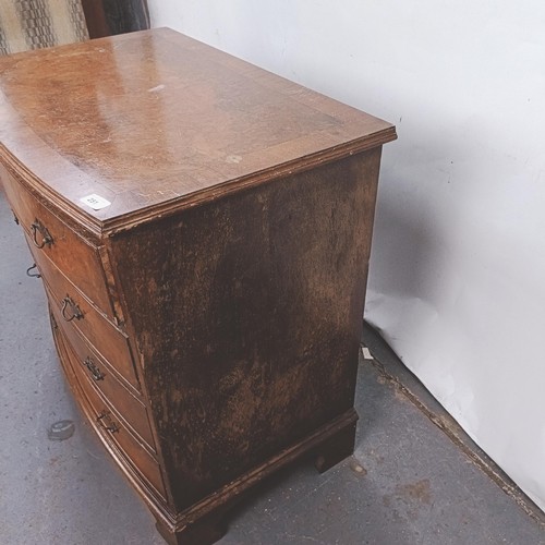 251 - A George III style walnut bow front chest, having four drawers