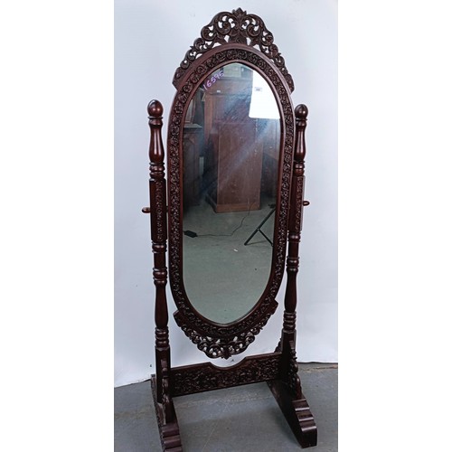 250 - A hardwood cheval mirror, profusely carved with foliate forms, 184 x 70 cm