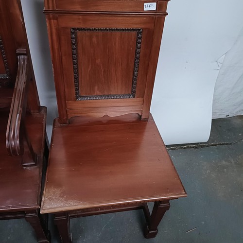 246 - A mahogany armchair, with a panel back and seat, and a matching pair of single chairs (3)