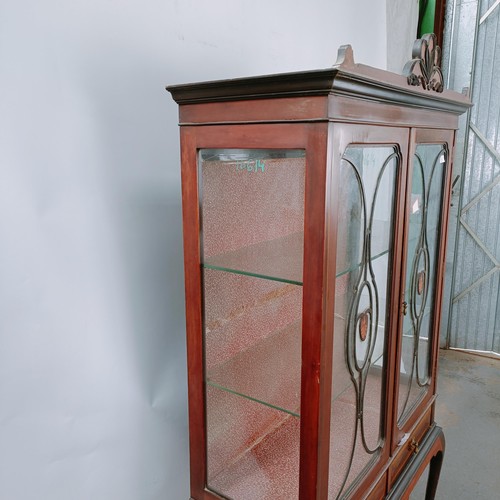 157 - An early 20th century mahogany display cabinet, with two glazed doors above two drawers on cabriole ... 