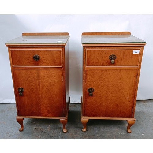 164 - A walnut dressing table, with five drawers, 123 cm wide, and two matching bedside cupboards (3)