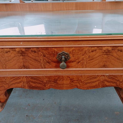 164 - A walnut dressing table, with five drawers, 123 cm wide, and two matching bedside cupboards (3)