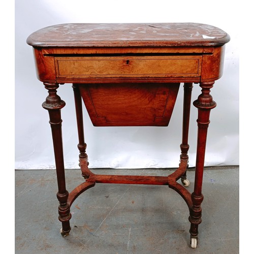 166 - A Victorian walnut work table, with a hinged top to reveal a fitted interior, on turned legs united ... 