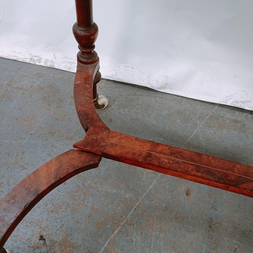 166 - A Victorian walnut work table, with a hinged top to reveal a fitted interior, on turned legs united ... 