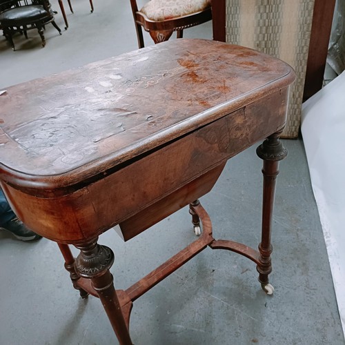 166 - A Victorian walnut work table, with a hinged top to reveal a fitted interior, on turned legs united ... 