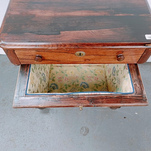 167 - A 19th century rosewood work table, with a single drawer above a silk rag box, on twin end supports ... 