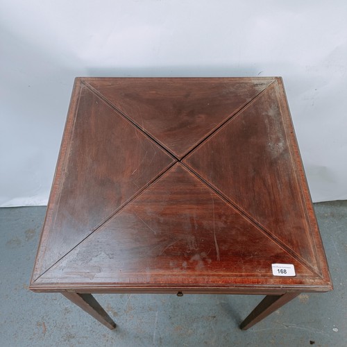 168 - An early 20th century mahogany envelope card table, with a single drawer, on square legs, 54 cm wide