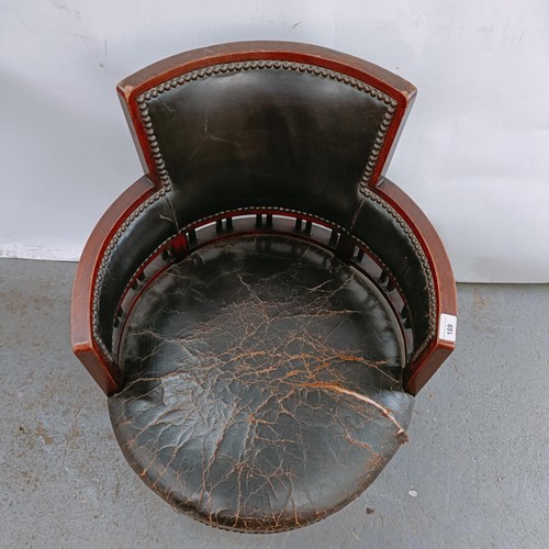 169 - A late Victorian mahogany and leather tub chair