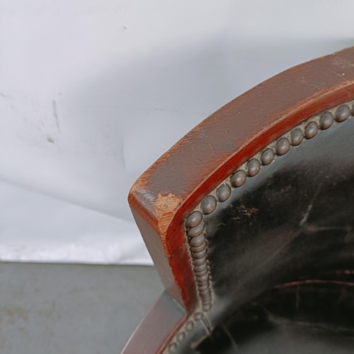 169 - A late Victorian mahogany and leather tub chair