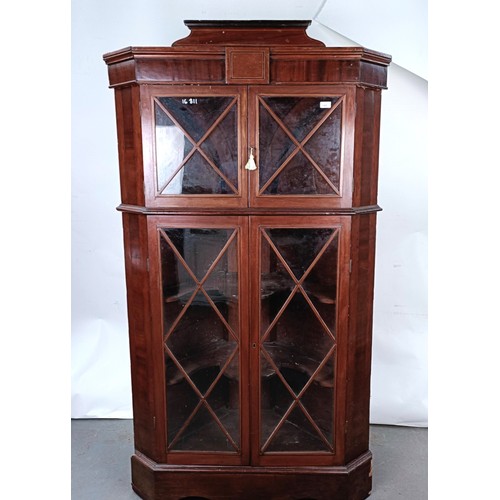 180 - A Victorian mahogany corner cabinet, the top with two glazed doors, the base with two glazed doors, ... 