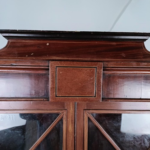 180 - A Victorian mahogany corner cabinet, the top with two glazed doors, the base with two glazed doors, ... 