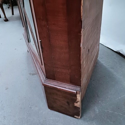 180 - A Victorian mahogany corner cabinet, the top with two glazed doors, the base with two glazed doors, ... 