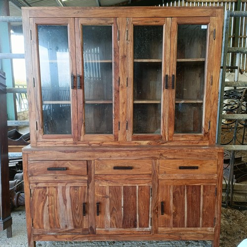 1 - A hardwood display cabinet, with three glazed doors, on a base with three drawers and three cupboard... 