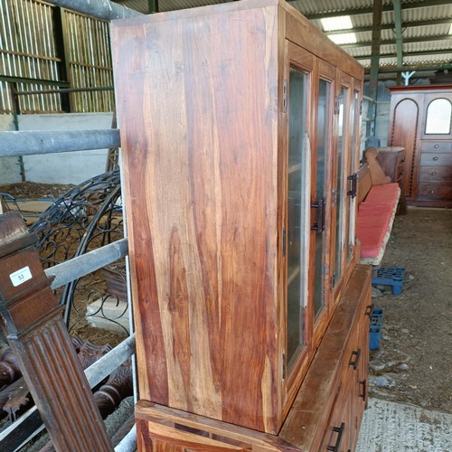 1 - A hardwood display cabinet, with three glazed doors, on a base with three drawers and three cupboard...