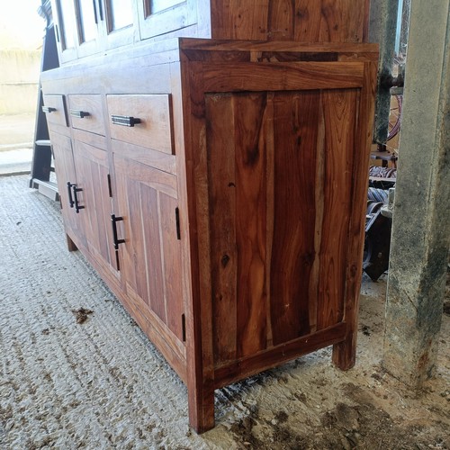 1 - A hardwood display cabinet, with three glazed doors, on a base with three drawers and three cupboard...