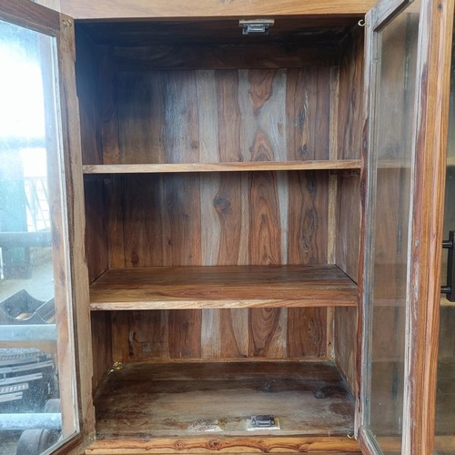 1 - A hardwood display cabinet, with three glazed doors, on a base with three drawers and three cupboard...