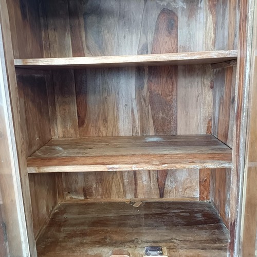 1 - A hardwood display cabinet, with three glazed doors, on a base with three drawers and three cupboard...