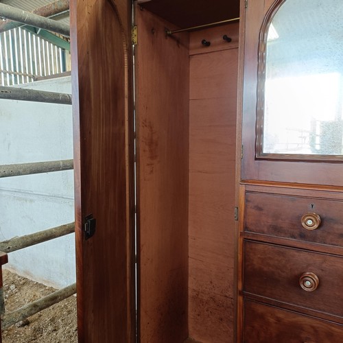 5 - A 19th century mahogany compactum, with two central mirrored doors, above two short and three long d...