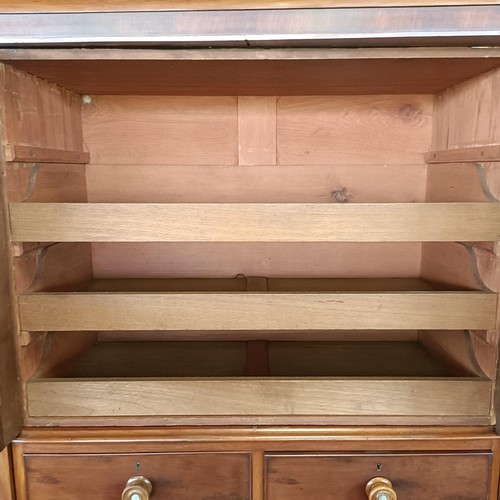 5 - A 19th century mahogany compactum, with two central mirrored doors, above two short and three long d...