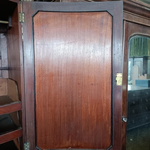 6 - A late 19th century Sheraton Revival inlaid mahogany bow front linen press, two cupboard doors to re...