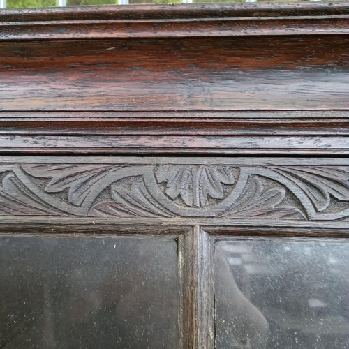 12 - A carved oak bookcase, with two drawers, 204 cm high, 100 cm wide<br /><br />Please note collection ...