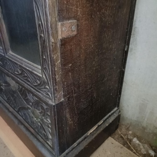 12 - A carved oak bookcase, with two drawers, 204 cm high, 100 cm wide<br /><br />Please note collection ...