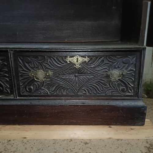 12 - A carved oak bookcase, with two drawers, 204 cm high, 100 cm wide<br /><br />Please note collection ...