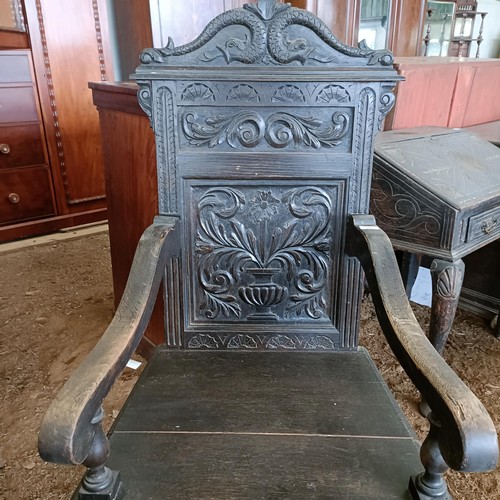 20 - An oak wainscot type chair, with a carved back<br /><br />Please note collection is from TA9 4LJ onl...