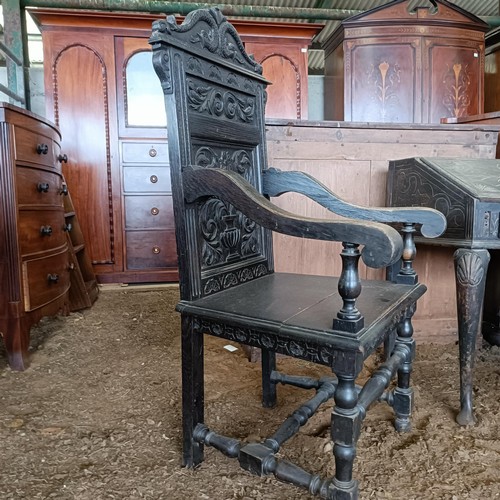 20 - An oak wainscot type chair, with a carved back<br /><br />Please note collection is from TA9 4LJ onl...