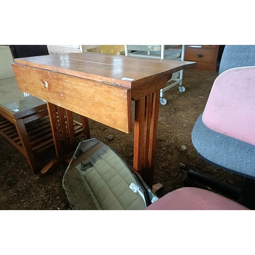 41 - An oak school desk, 80 cm wide, four mirrors, two office chairs, an oval oak table, and a sewing mac...