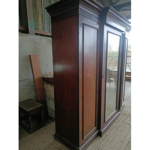 43 - A Victorian mahogany triple wardrobe, with a central mirrored door, 220 cm wide<br /><br />Please no...