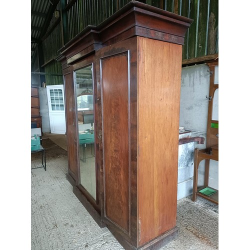 43 - A Victorian mahogany triple wardrobe, with a central mirrored door, 220 cm wide<br /><br />Please no...