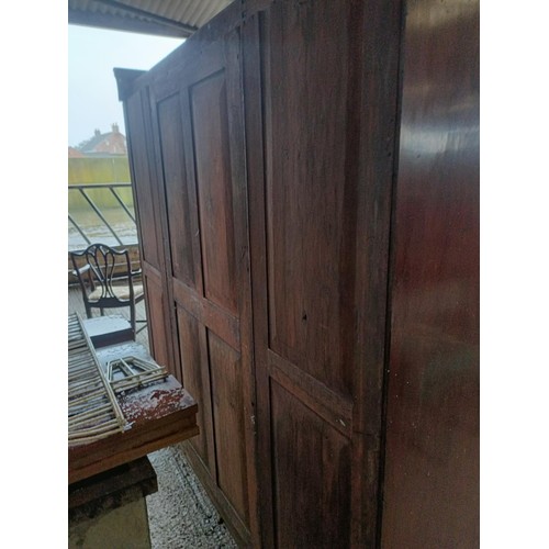 43 - A Victorian mahogany triple wardrobe, with a central mirrored door, 220 cm wide<br /><br />Please no...