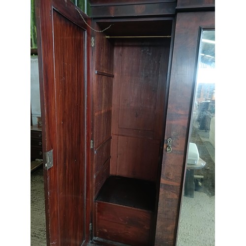 43 - A Victorian mahogany triple wardrobe, with a central mirrored door, 220 cm wide<br /><br />Please no...