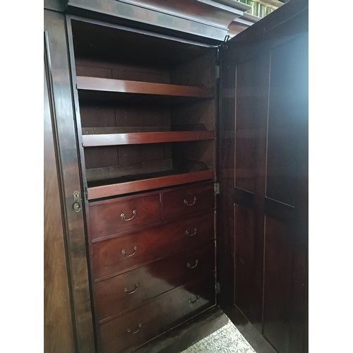 43 - A Victorian mahogany triple wardrobe, with a central mirrored door, 220 cm wide<br /><br />Please no...