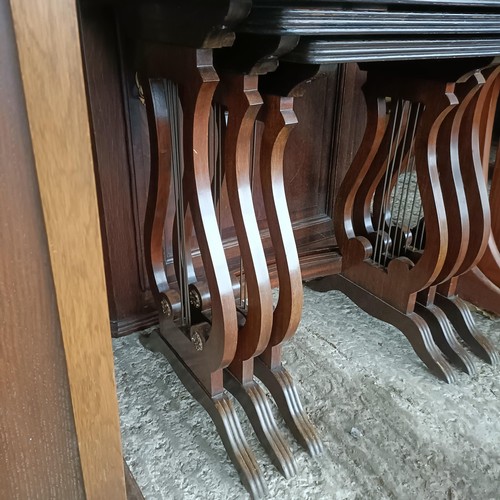 48 - An oak glazed bookcase, 96 cm wide, a nest of three tables, a corner cabinet, and an oak glazed book...