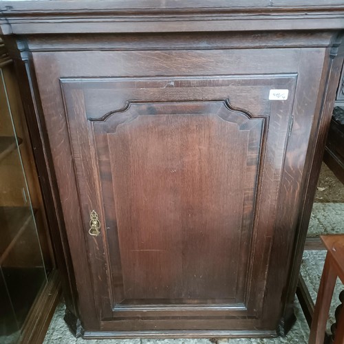 48 - An oak glazed bookcase, 96 cm wide, a nest of three tables, a corner cabinet, and an oak glazed book...