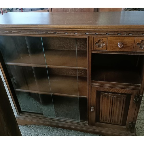 48 - An oak glazed bookcase, 96 cm wide, a nest of three tables, a corner cabinet, and an oak glazed book...