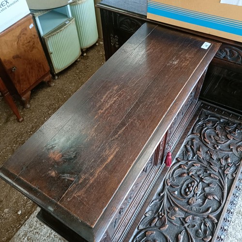 49 - A carved oak writing desk, with a hinged fall front, 84 cm wide<br /><br />Please note collection is...